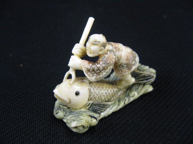 Appraisal: CArved Ivory Netsuke of a Man Spearinga huge fish signed