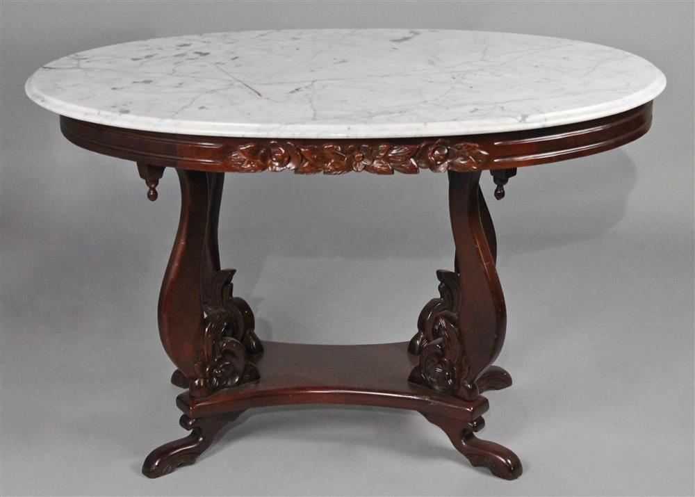 Appraisal: VICTORIAN STYLE OVAL CARRARA MARBLE TOPPED MAHOGANY TABLE having a