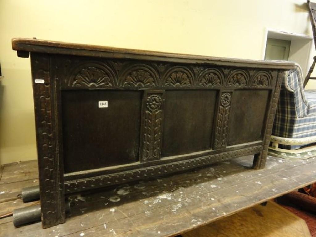 Appraisal: A Georgian oak coffer with panelled frame and carved front