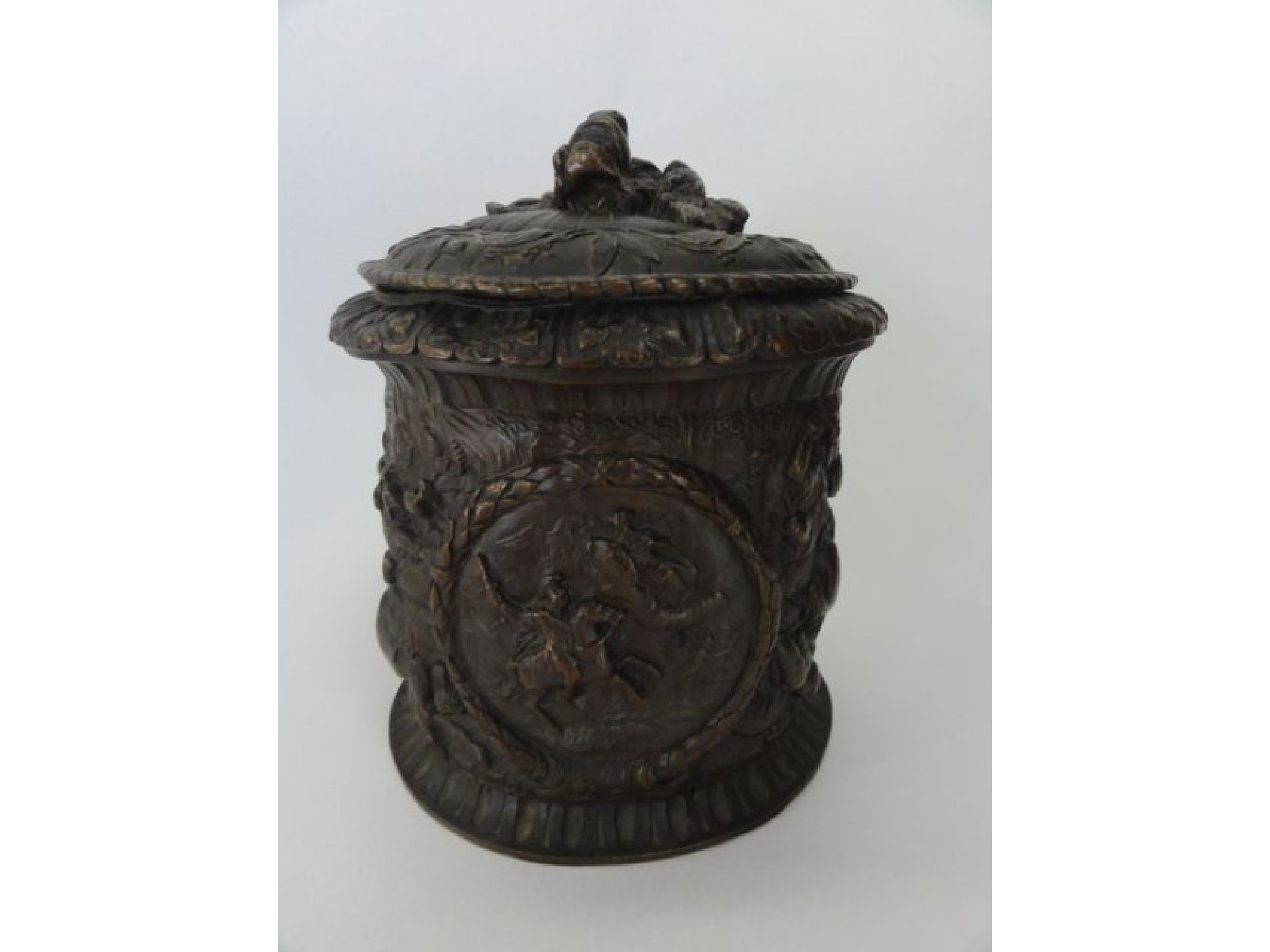 Appraisal: A cast metal vessel of cylindrical form with deep embossed