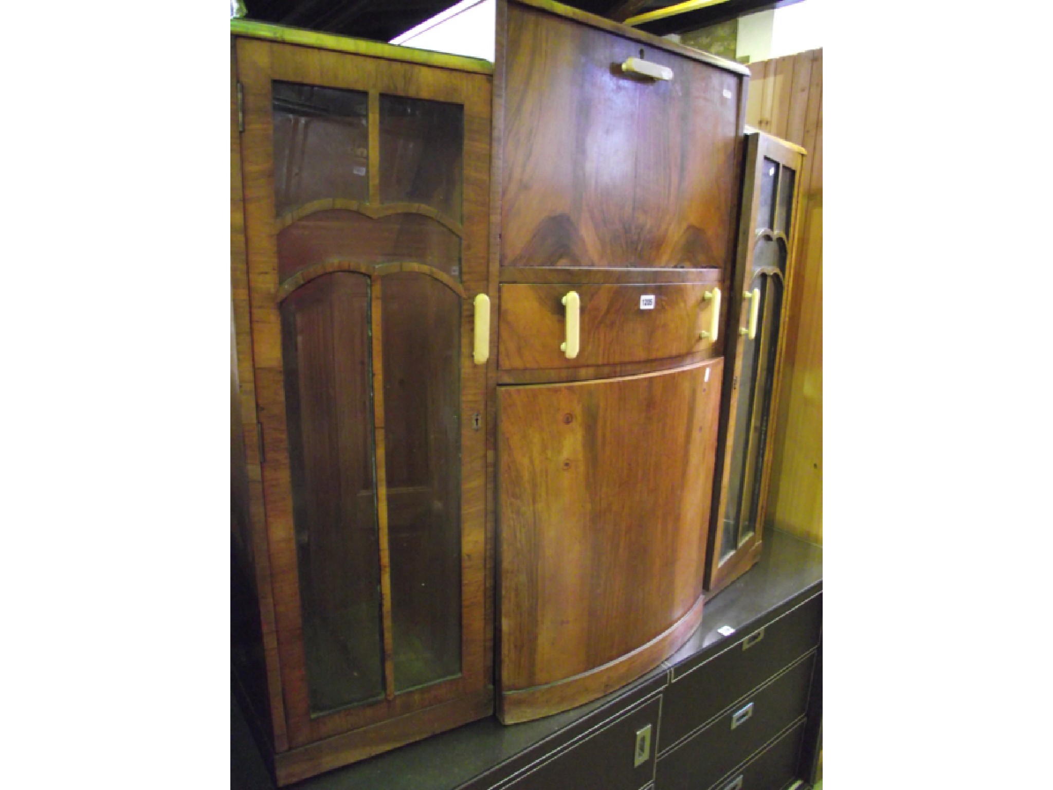 Appraisal: An Art Deco figured walnut bureau cabinet the central bureau