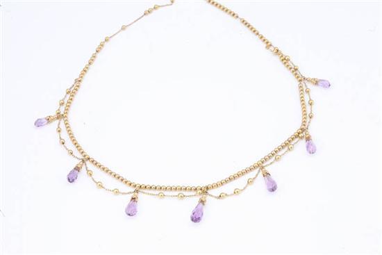 Appraisal: AMETHYST BRIOLETTE AND DRAPE NECKLACE Gold beads make up the