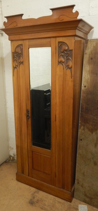 Appraisal: An Art Nouveau satin walnut single mirror door wardrobe with