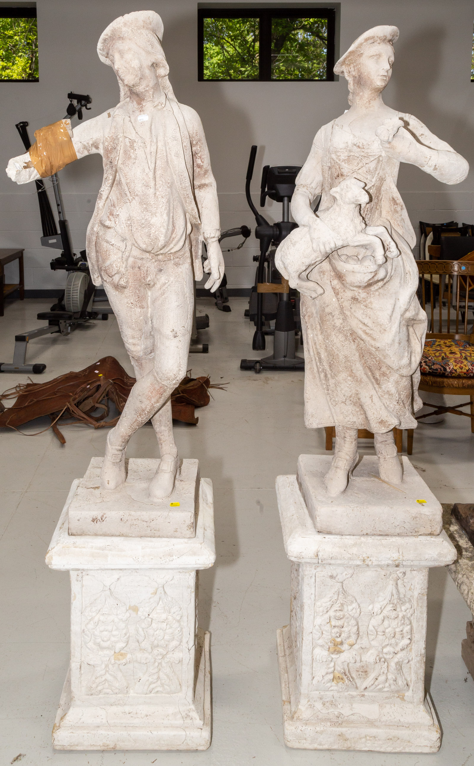 Appraisal: A PAIR OF WEATHERED GARDEN FIGURES th century modeled as