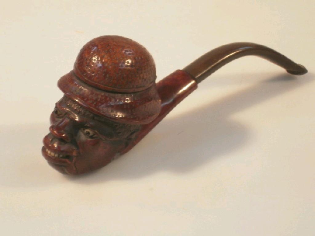 Appraisal: A thC carved hardwood pipe in the form of a