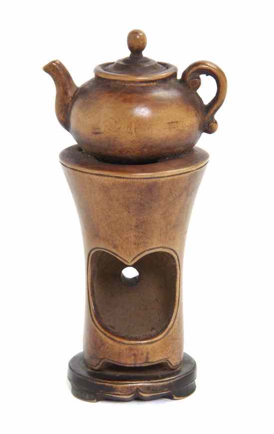 Appraisal: A Carved Wood Netsuke depicting a teapot on stand unsigned