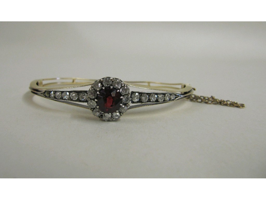 Appraisal: Victorian gold garnet and diamond set bangle with central flower