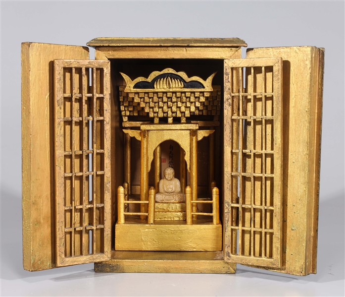 Appraisal: Japanese Butsudan shrine black exterior gilt interior with seated Buddha