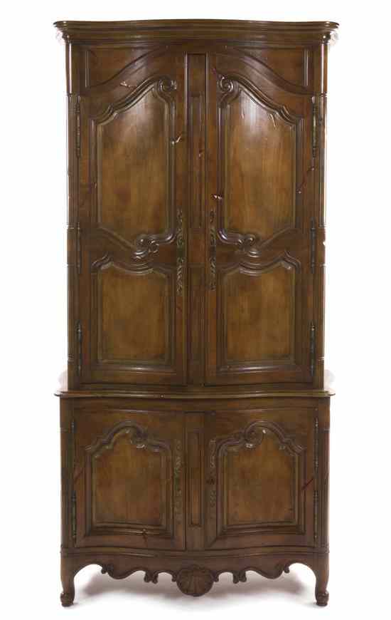 Appraisal: A French Provincial Walnut Armoire having a shaped and molded