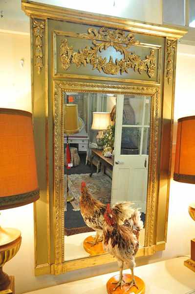 Appraisal: A CONTINENTAL STYLE GILT WALL MIRROR WITH OLIVE PAINTED SURROUND