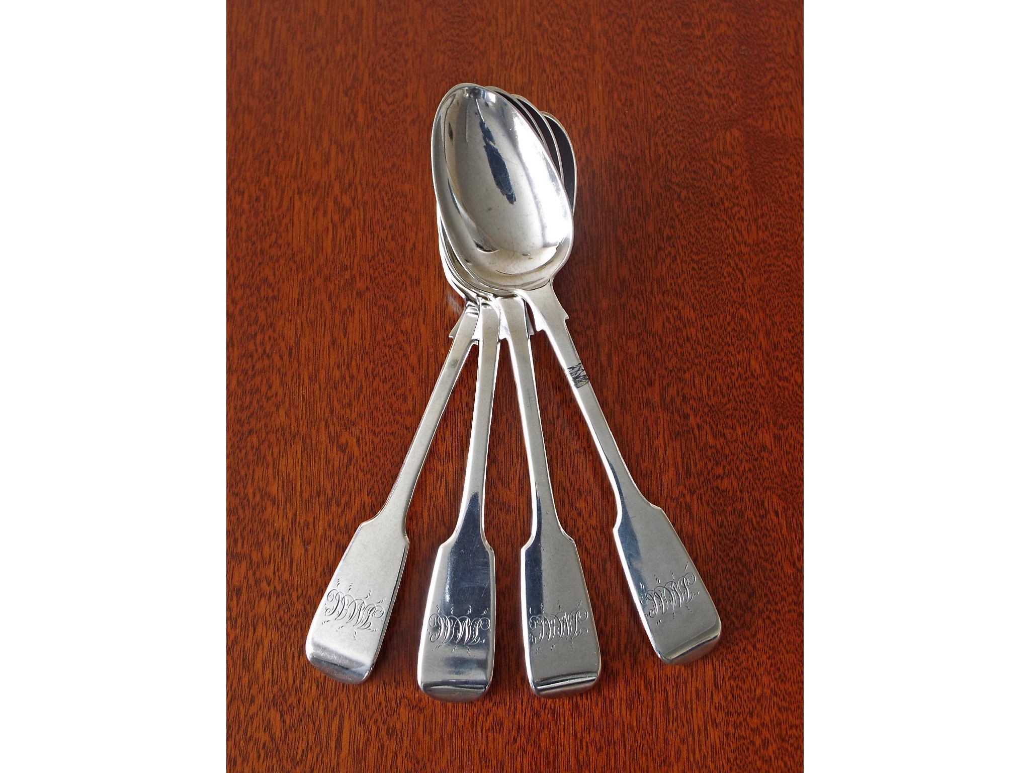 Appraisal: Set of four Victorian silver fiddle pattern dessert spoons maker