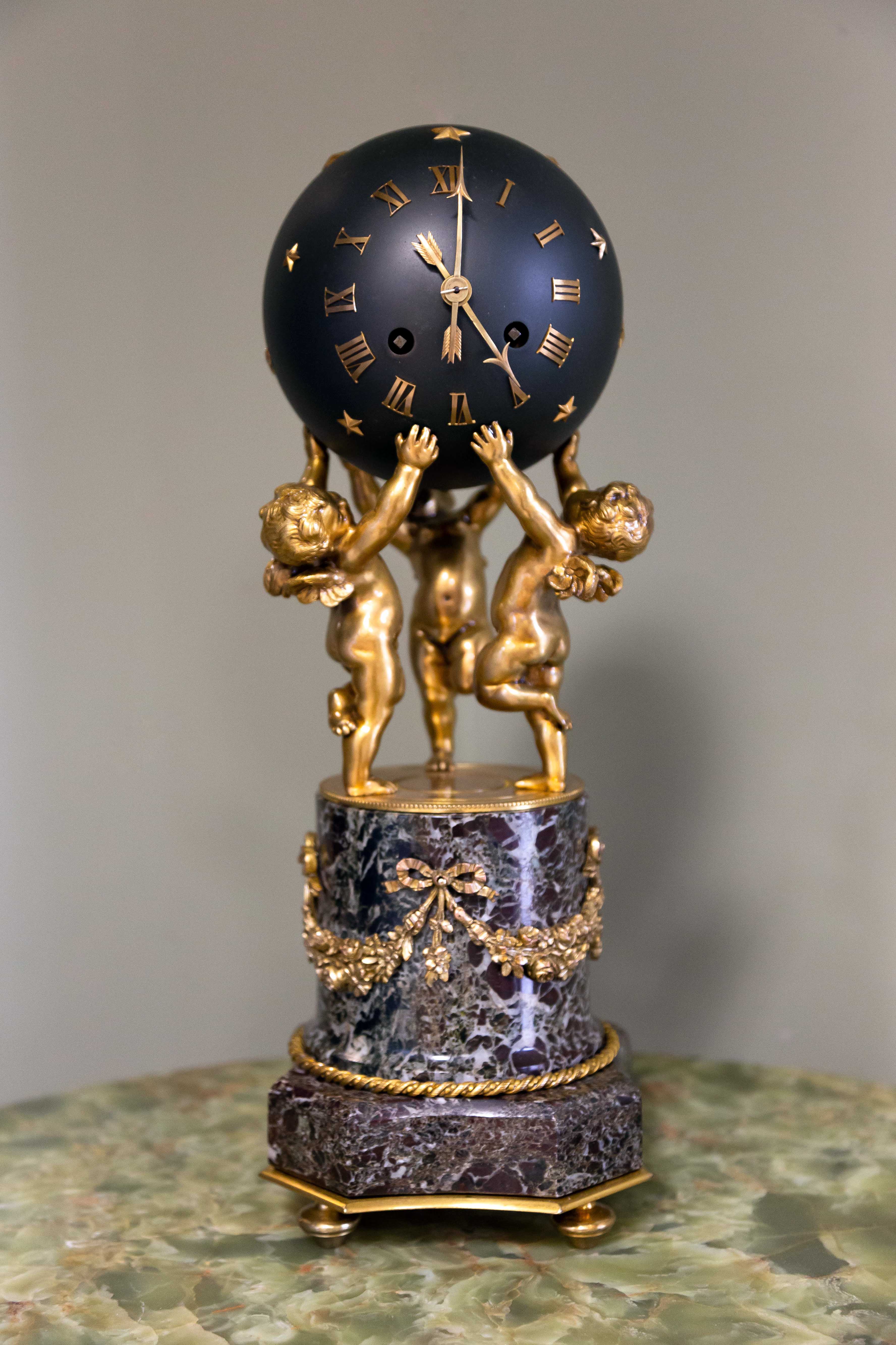 Appraisal: FRENCH SPHERE CLOCK WITH BRONZE CHERUBS th Century On a