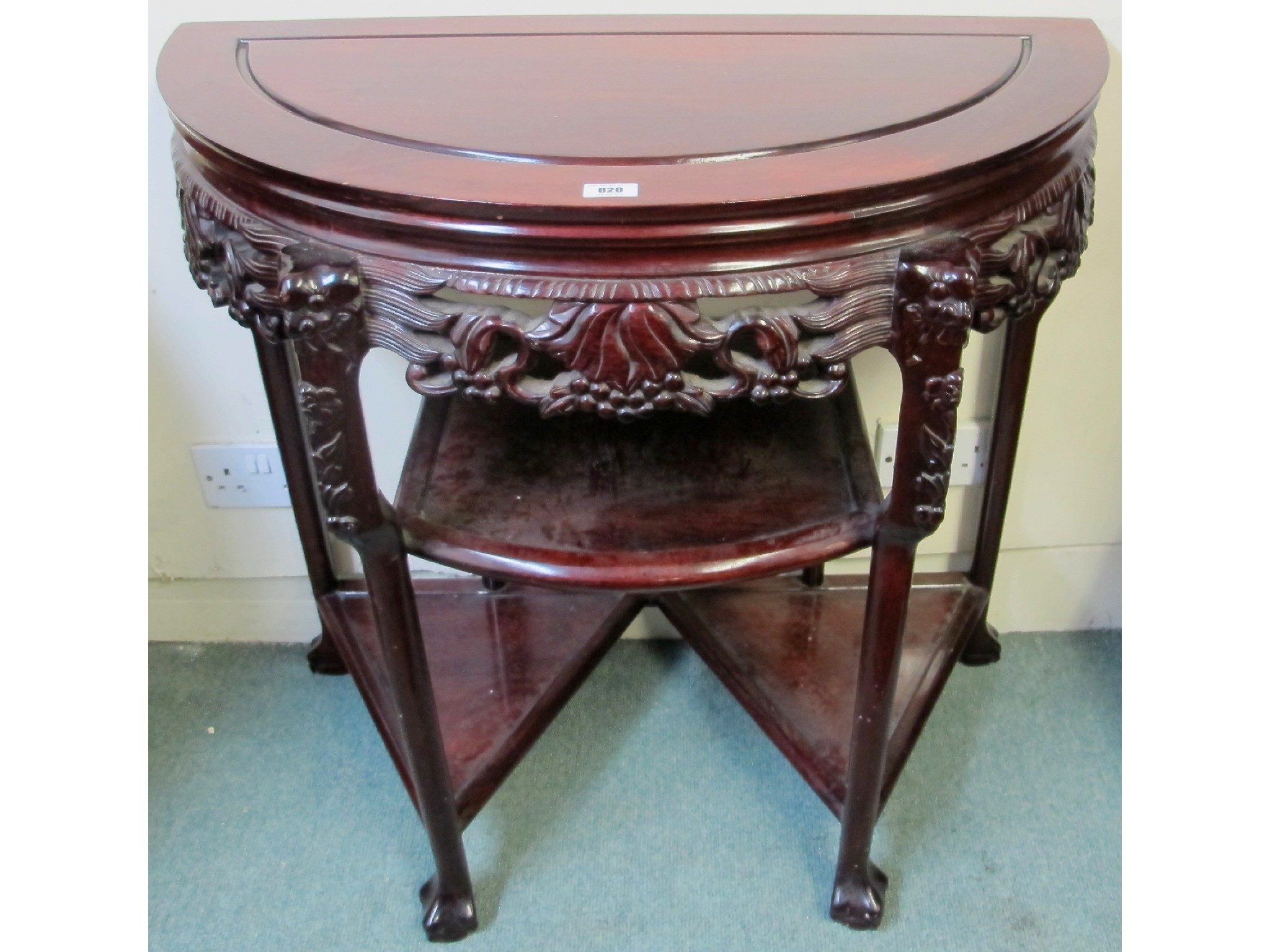 Appraisal: A Chinese demi-lune hardwood hall table carved with fruit