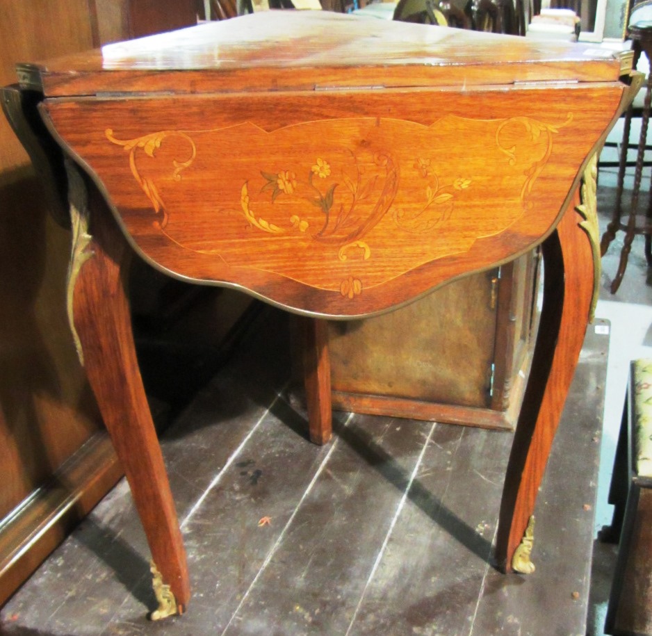 Appraisal: A gilt metal mounted marquetry inlaid triangular drop flap table