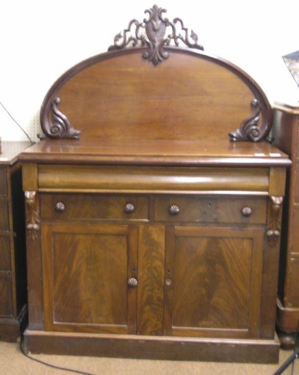 Appraisal: A Victorian mahogany sideboard with carved raised back moulded frieze