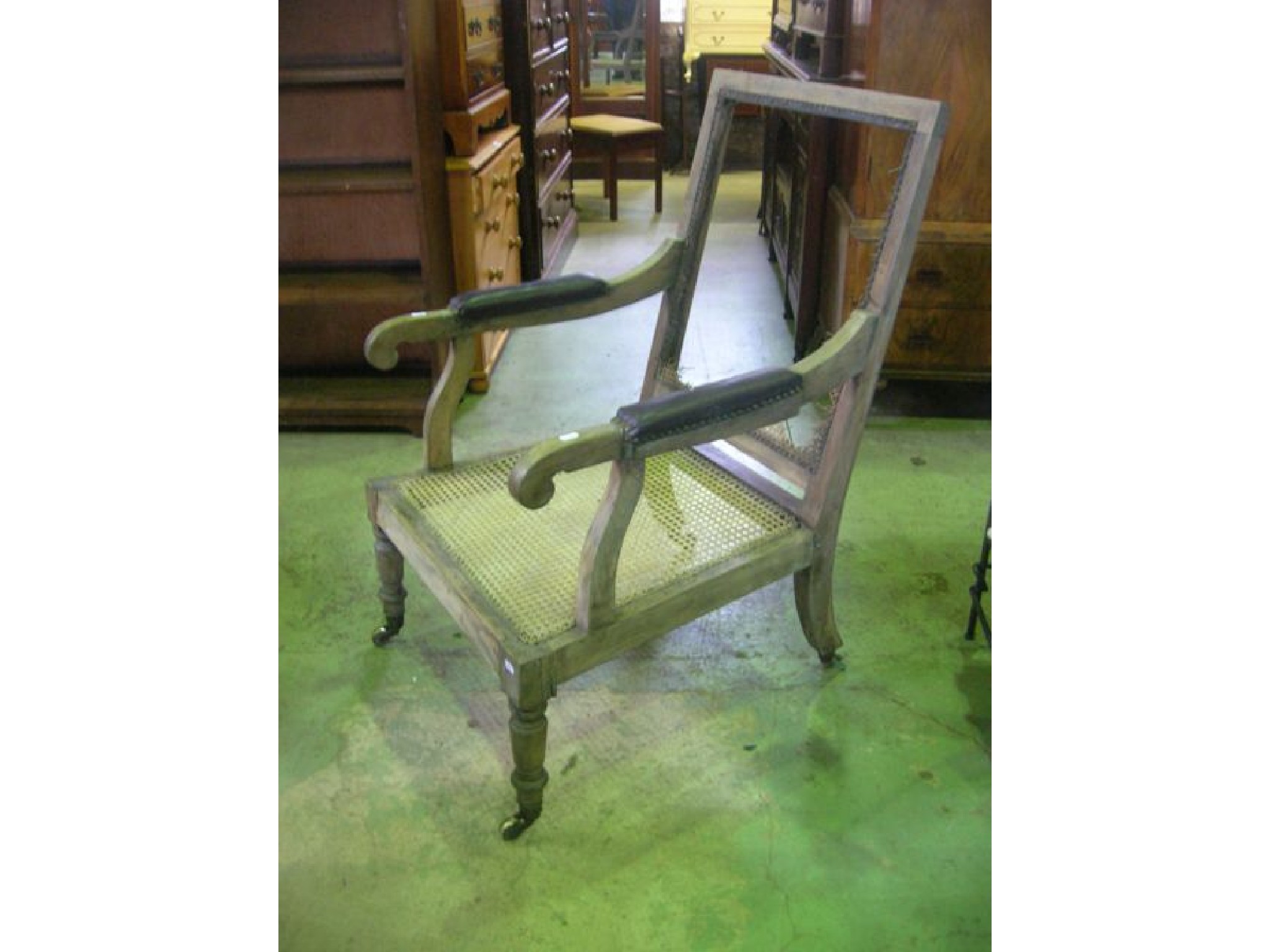 Appraisal: A th century oak framed library chair with cane panelled