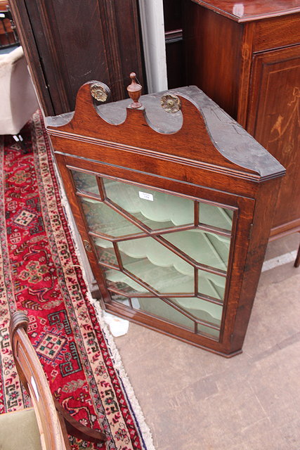 Appraisal: A GEORGE III OAK HANGING CORNER CABINET with swan neck