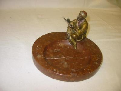 Appraisal: A COLD PAINTED BRONZE ASHTRAY the dark red hard stone