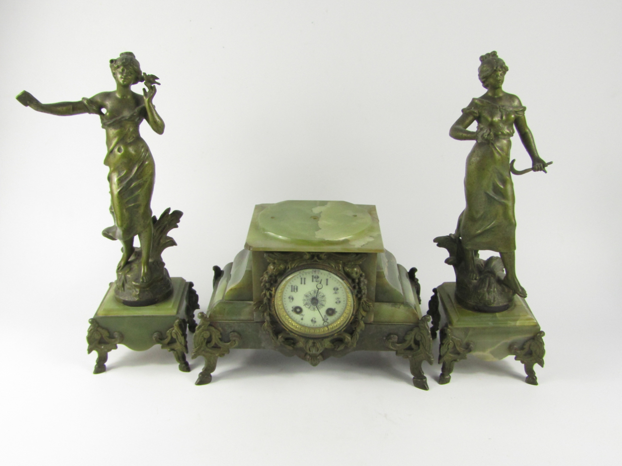 Appraisal: A French onyx and metal clock garniture clock with enamel