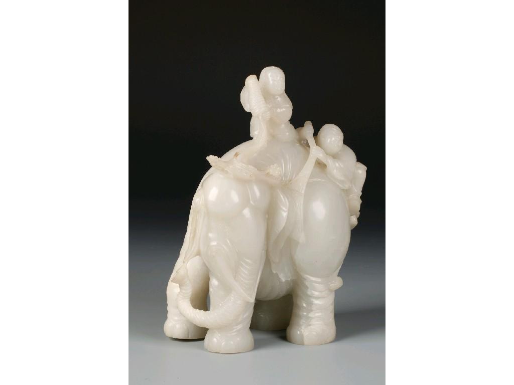 Appraisal: A CHINESE WHITE JADE ELEPHANT carved with figures holding branches