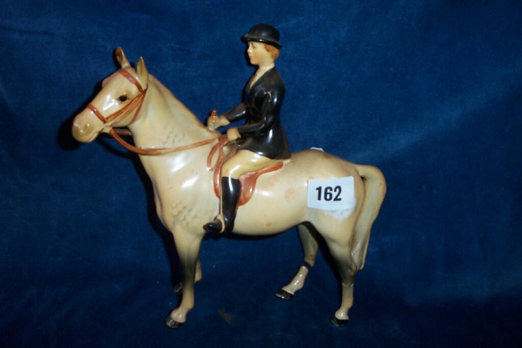 Appraisal: A Beswick model of a huntswoman on a white horse