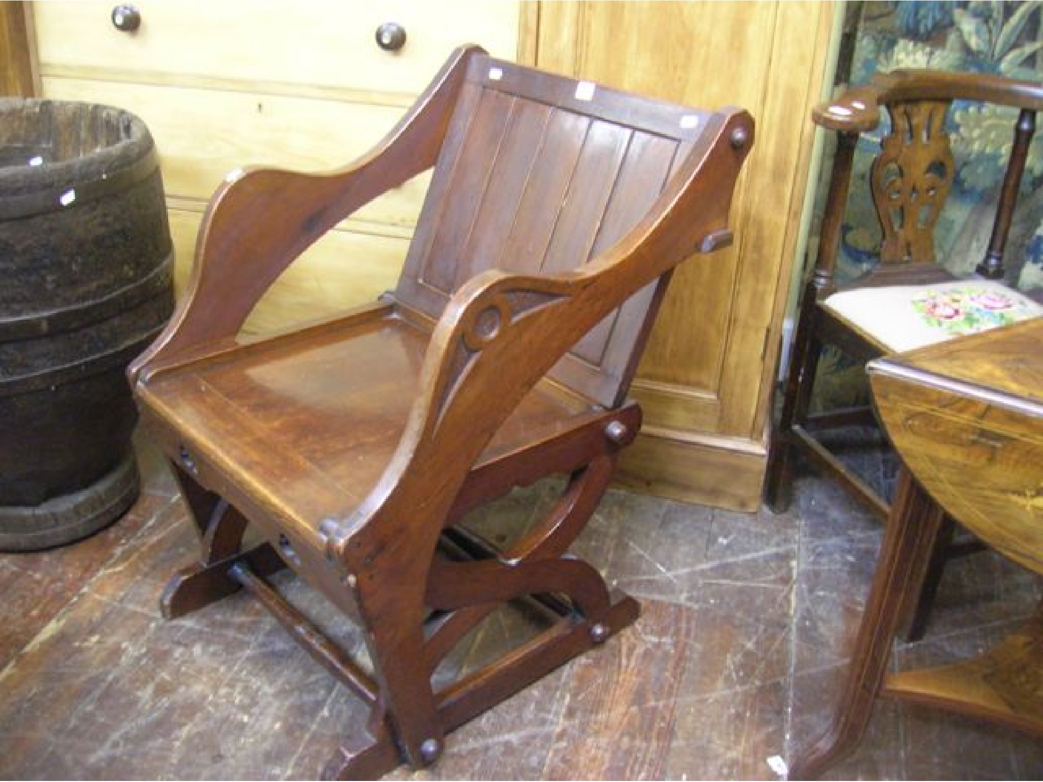 Appraisal: A Victorian pitch pine Glastonbury chair the reverse panel incorporating