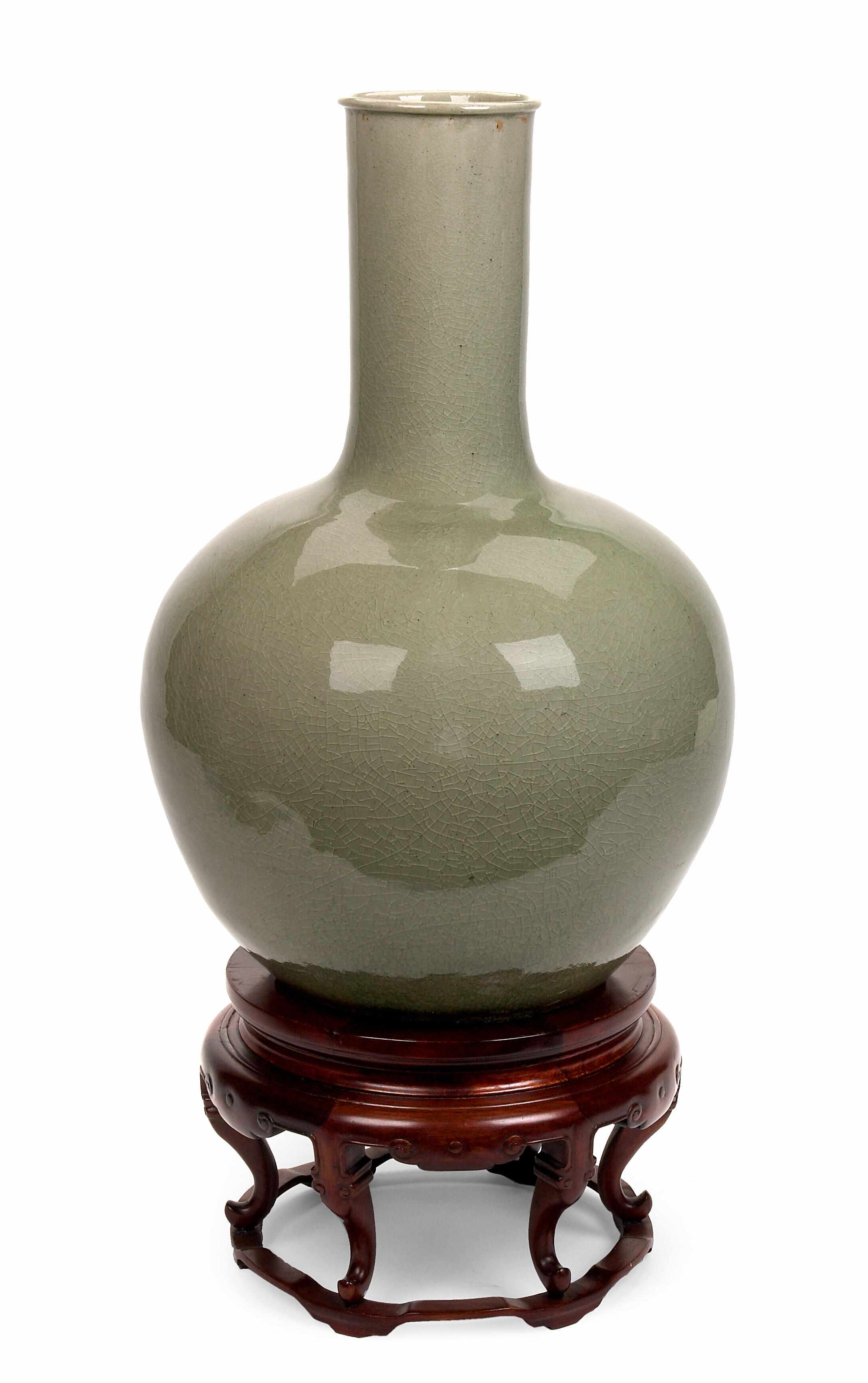 Appraisal: A Thai celadon glazed ceramic vase th centuryon a wood