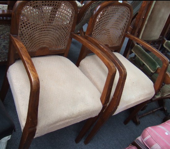 Appraisal: A pair of mid th century walnut open armchairs with