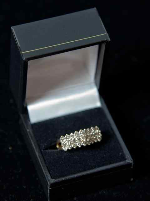 Appraisal: DIAMOND THREE STONE RING set with a row of three