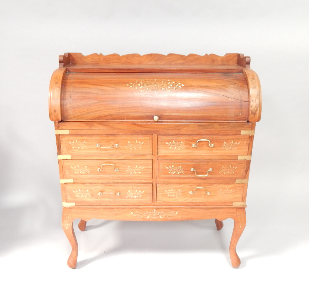 Appraisal: A mahogany roll top desk having brass inlaid central cartouche