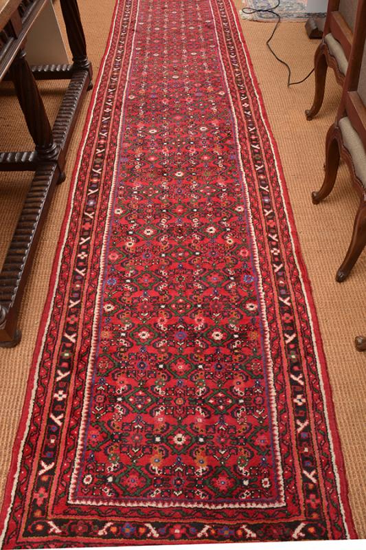 Appraisal: A PERSIAN FLOOR RUNNER with a foliate field within geometric