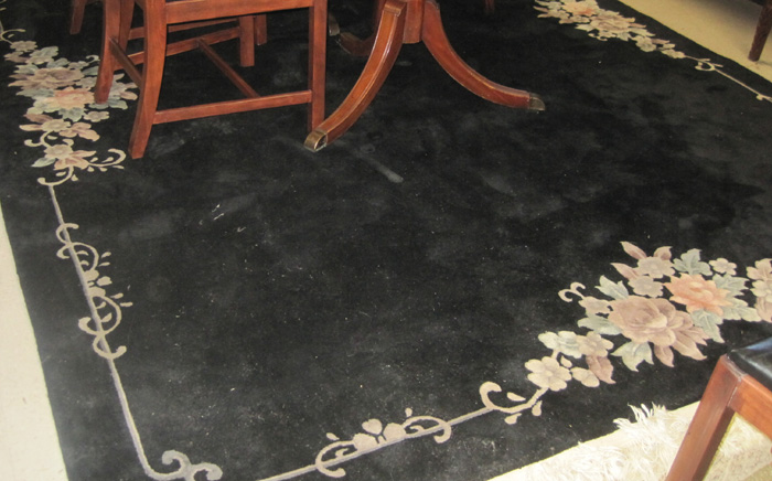 Appraisal: HAND KNOTTED CHINESE CARPET featuring an undecorated black field with