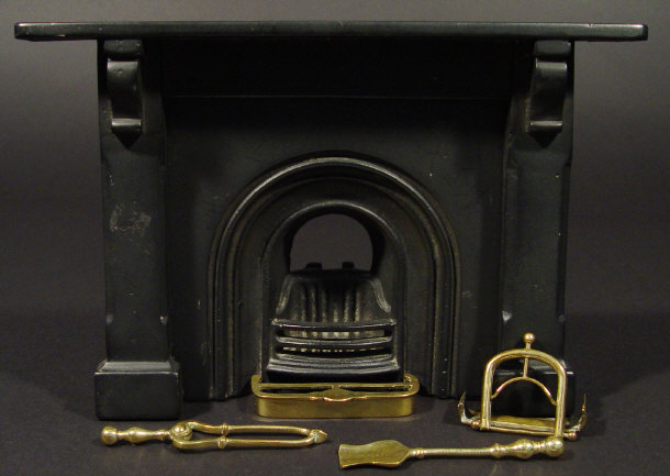 Appraisal: Victorian cast iron miniature fireplace and mantelpiece a brass fender