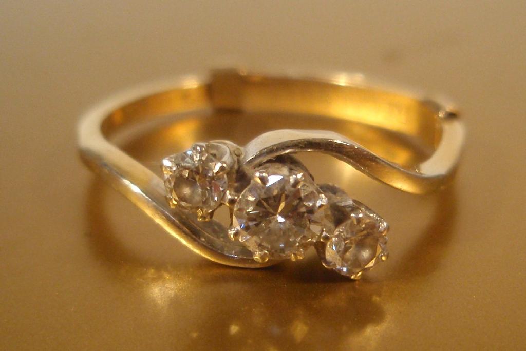 Appraisal: An ct gold three stone diamond twist ring