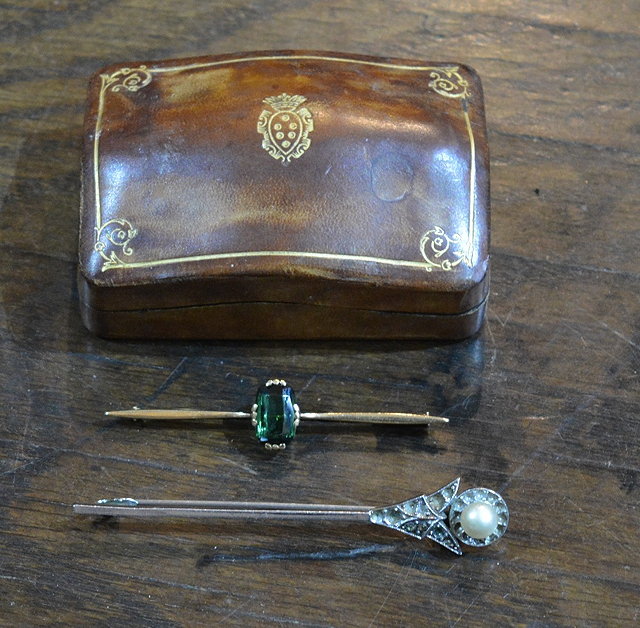 Appraisal: A bar broochmounted with a peridot a pearl mounted Art