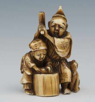 Appraisal: A Carved Ivory Netsuke Carved ivory group depicting a couple