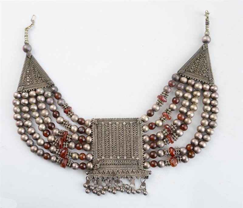 Appraisal: NORTH AFRICAN SILVERED METAL AND AMBER-GLASS NECKLACE The bead-hung central