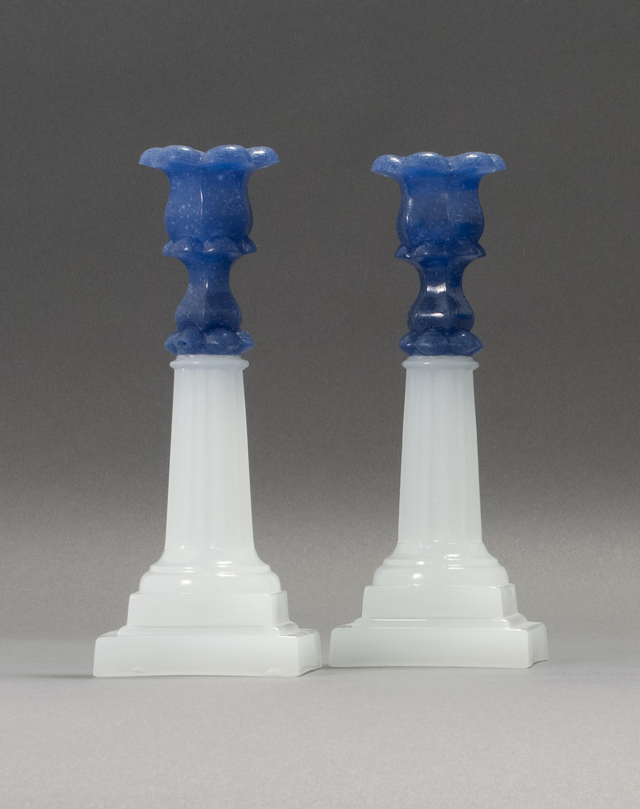 Appraisal: PAIR OF SANDWICH GLASS COMPANY PRESSED GLASS COLUMN CANDLESTICKS Mid-