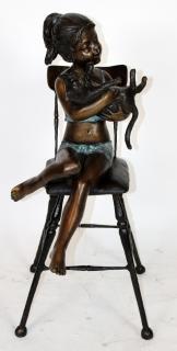 Appraisal: Bronze statue of girl sitting in chair with kitten Bronze