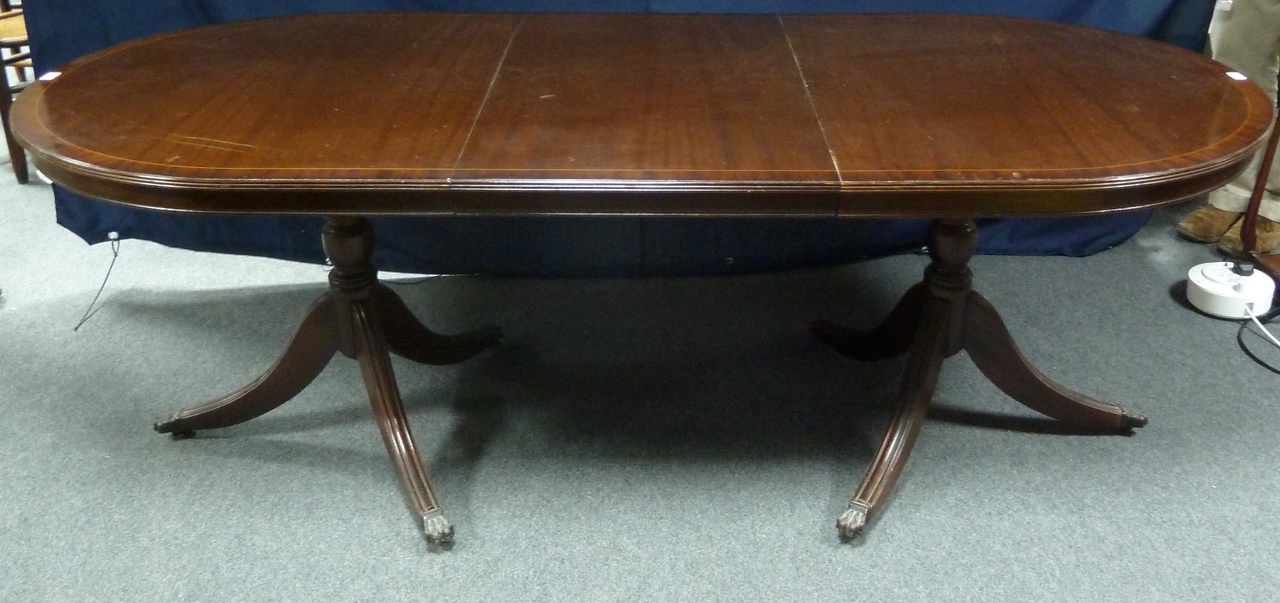 Appraisal: A th Century mahogany two-pillar dining table with two extending