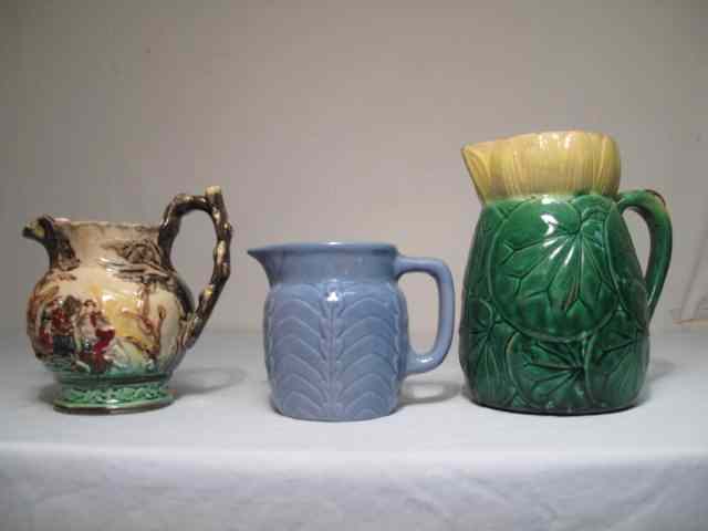 Appraisal: Three Majolica pottery pitchers One with water lily design and