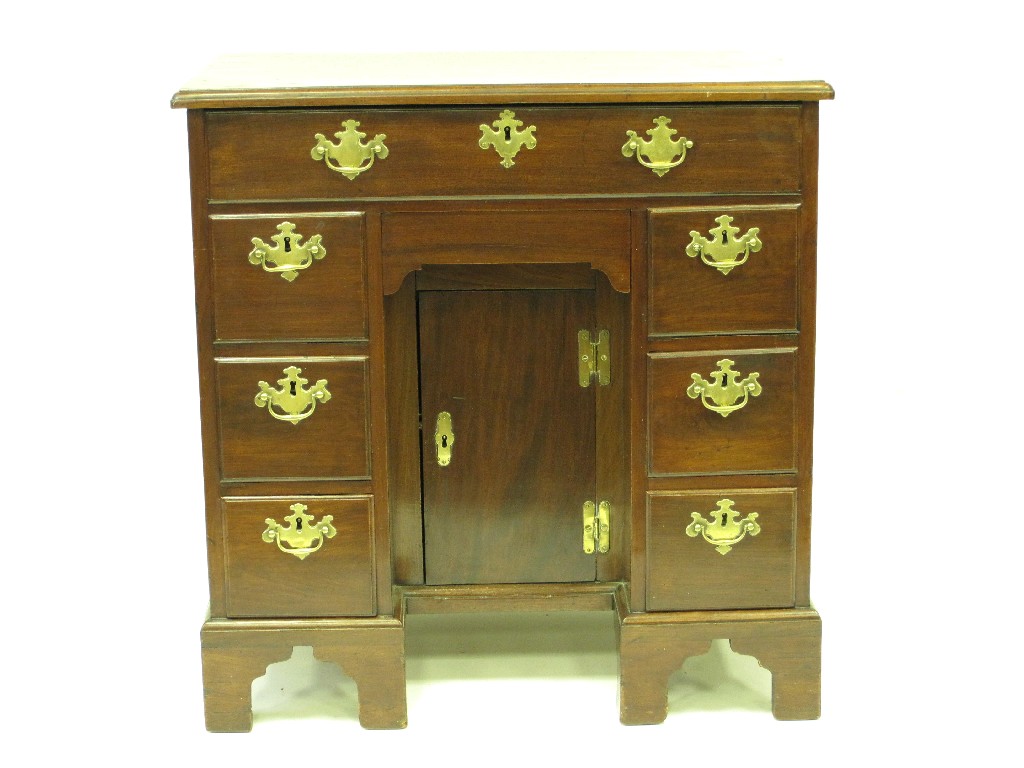 Appraisal: An th Century red walnut Kneehole Desk having moulded top