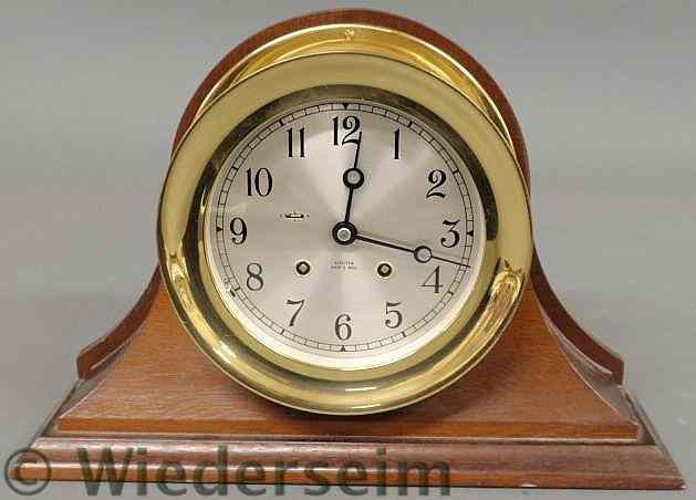 Appraisal: Chelsea brass ship's bell clock mounted on a mahogany base