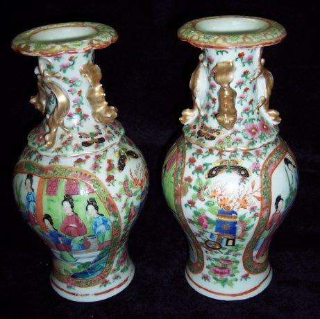 Appraisal: A pair of Cantonese famille rose vases decorated panels of