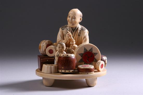 Appraisal: JAPANESE IVORY OKIMONO OF MUSICIAN Seated with child surrounded by