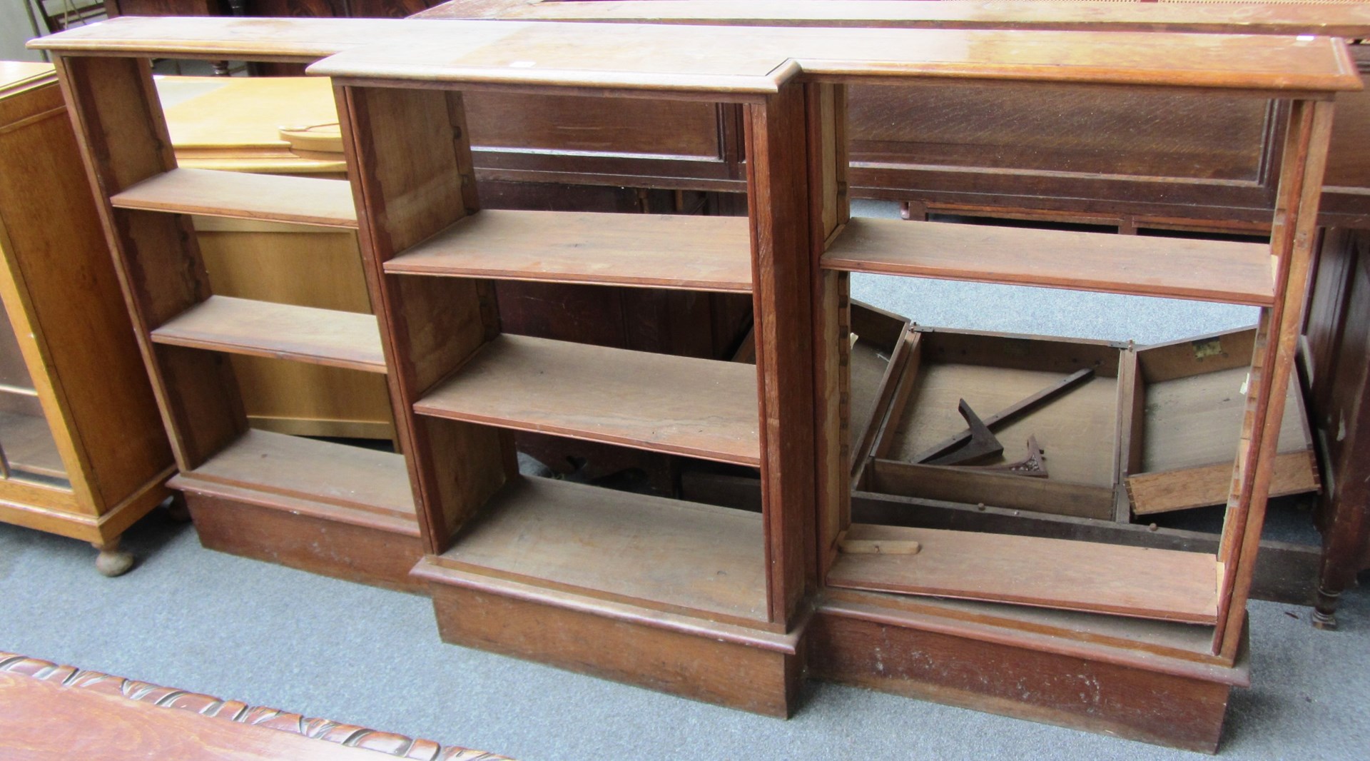 Appraisal: An early th century oak breakfront floor standing open bookcase