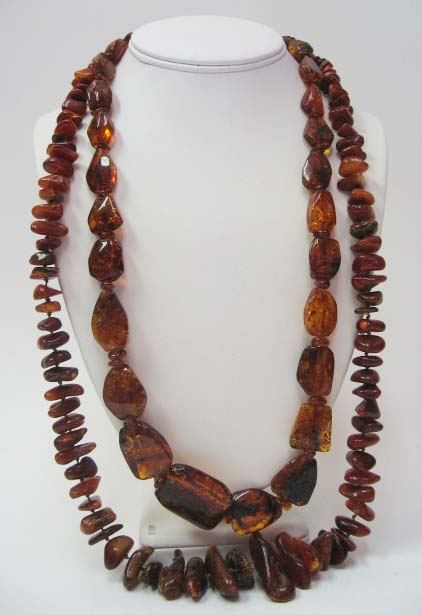 Appraisal: Two Amber Bead Necklaces both of a dark honey color