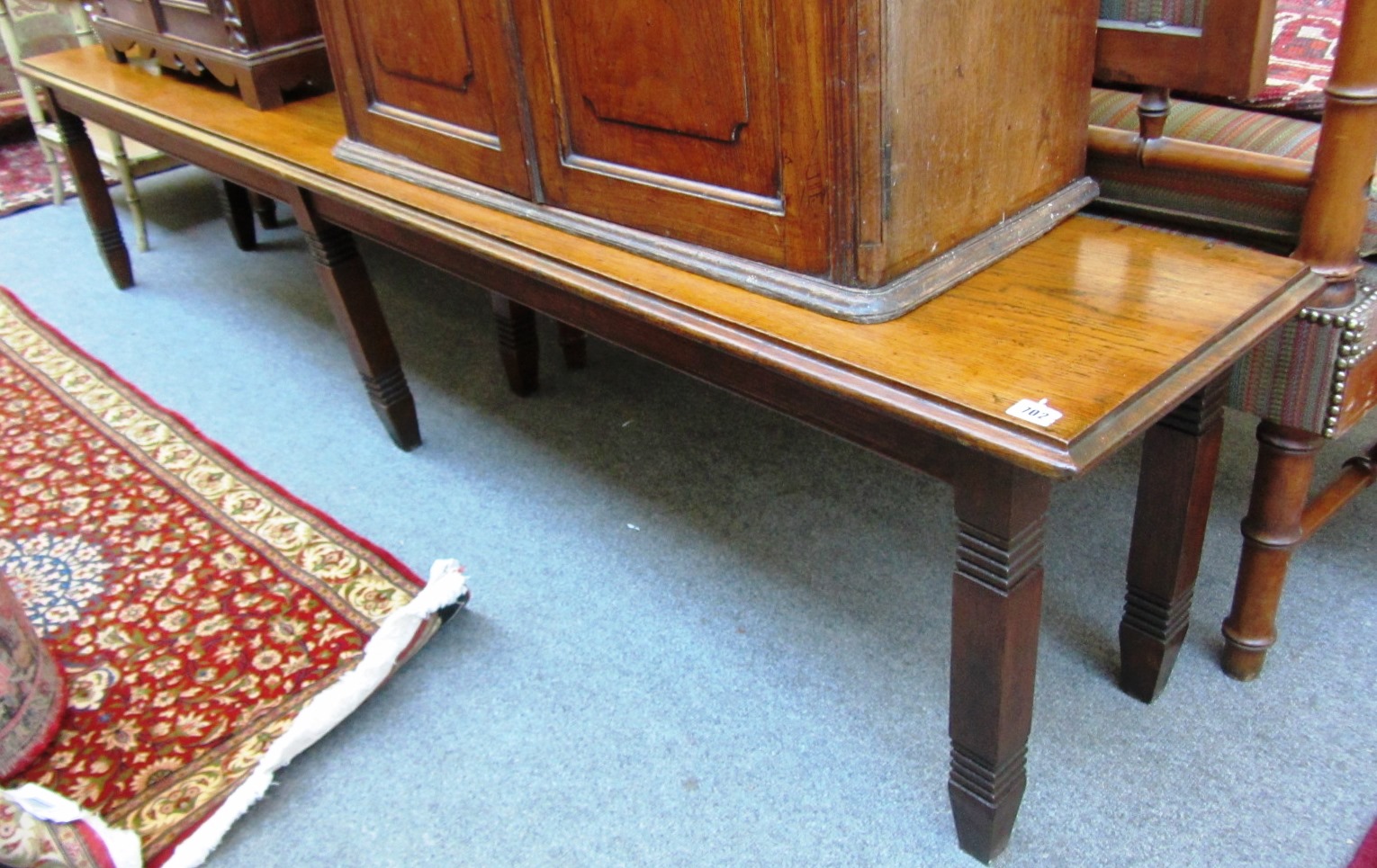 Appraisal: A large oak bench the rectangular top on six square