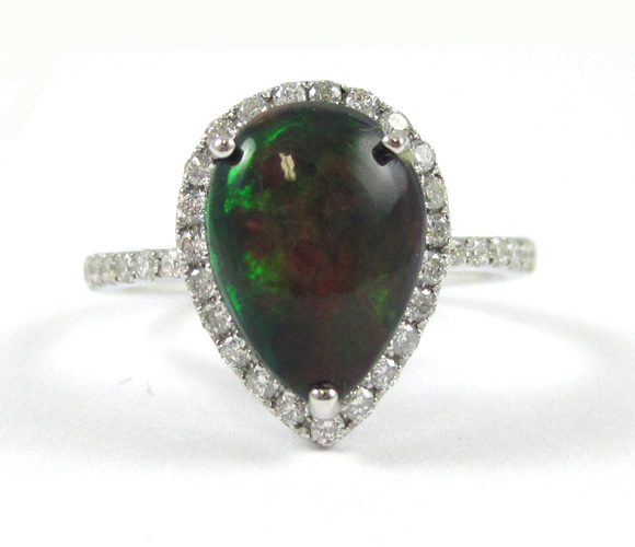 Appraisal: BLACK OPAL AND FOURTEEN KARAT WHITE GOLD RING with round-cut