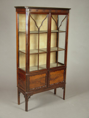 Appraisal: A Chippendale revival mahogany display cabinet the canted moulded cornice